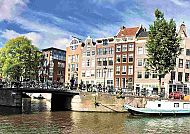 Amsterdam, Idyllische Grachtenansicht in Amsterdam mit historischen Gebäuden., Malerische Grachtenhäuser und Brücke in Amsterdam.