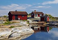 Stockholm - Schären, Rote Holzhäuser auf den Schären bei Stockholm, idyllische Landschaft., Rote Holzhäuser in den idyllischen Schären von Stockholm.