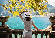 Gardasee, Frau genießt den Blick auf den Gardasee unter herbstlichen Bäumen., Frau genießt den Blick auf den Gardasee unter herbstlichen Bäumen.