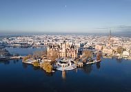 , Schweriner Schloss im Winter, umgeben von glitzerndem Wasser., Schweriner Schloss im Winter, umgeben von verschneiter Landschaft.
