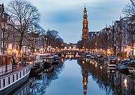Abendstimmung an Amsterdams Grachten mit Westerkerk im Hintergrund.