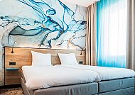 , Modernes Hotelzimmer mit kunstvoller Wandgestaltung in Blau., Modernes Hotelzimmer mit stilvollem Wanddesign in Blau- und Holztönen.