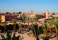 Marrakesch, Marrakesch: Lebendige Altstadt mit Palmen und traditioneller Architektur., Blick auf Marrakeschs lebendige Altstadt mit Palmen und Minarett.