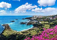 , Küstenblick auf Santa Cruz, Spanien mit blühenden Bougainvilleen.