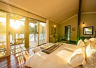 Cascades Safari Lodge, Zimmerbeispiel, Elegantes Zimmer in der Cascades Safari Lodge bei Sonnenuntergang., Helles, gemütliches Zimmer in der Cascades Safari Lodge.