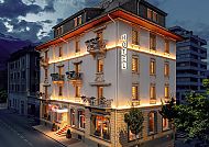 Hotel Ambassador, Brig, Außenansicht, Beleuchtetes Hotel Ambassador in Brig bei Nacht.